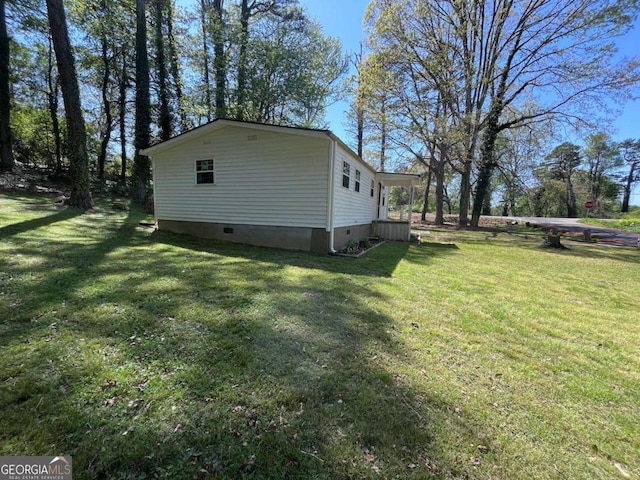 view of property exterior featuring a lawn and crawl space