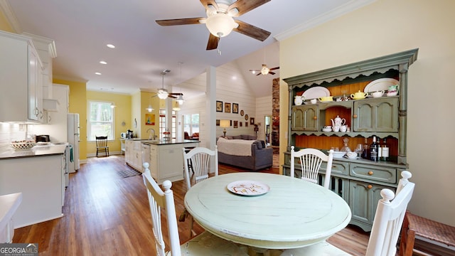 dining space featuring crown molding, a ceiling fan, and wood finished floors