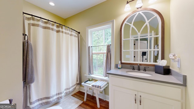 full bathroom with wood finished floors and vanity