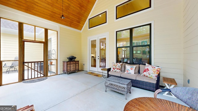 sunroom with an outdoor living space and french doors