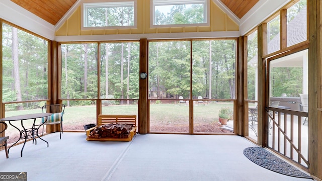 sunroom featuring a wooded view