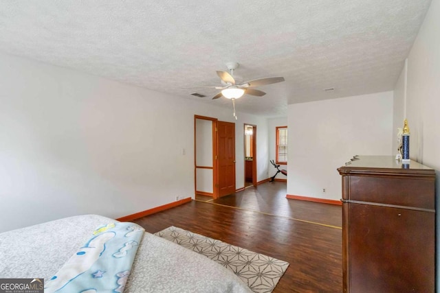 5152 Clearwater Dr, Stone Mountain, GA 30087 - bedroom with a textured ceiling, a ceiling fan, baseboards, wood finished floors, and visible vents