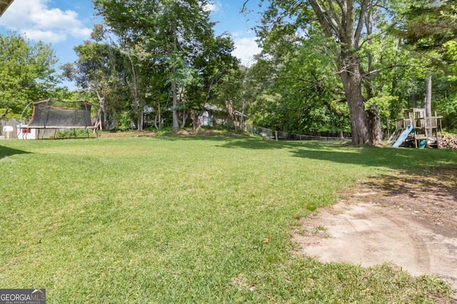 5152 Clearwater Dr, Stone Mountain, GA 30087 - view of yard featuring a playground, fence, and a trampoline