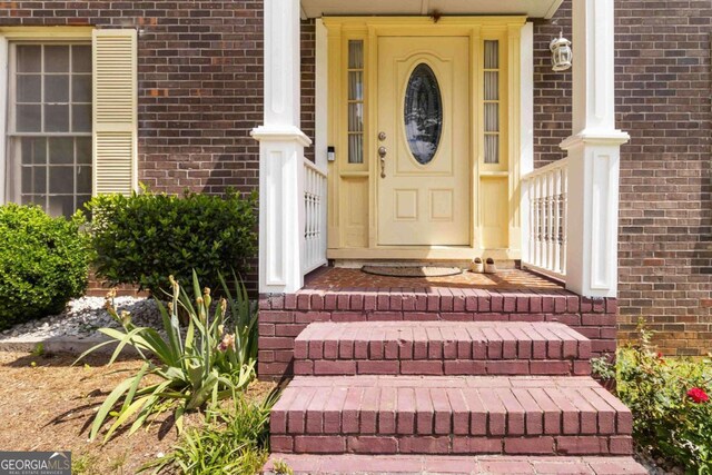 5152 Clearwater Dr, Stone Mountain, GA 30087 - view of exterior entry featuring brick siding