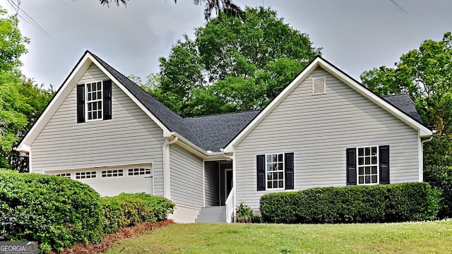 931 Justin Dr, Winder, GA 30680 - view of front of home featuring roof with shingles, an attached garage, and a front yard