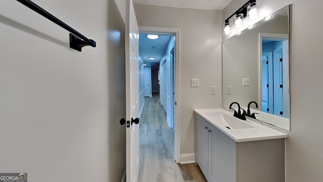 931 Justin Dr, Winder, GA 30680 - bathroom with baseboards, wood finished floors, and vanity