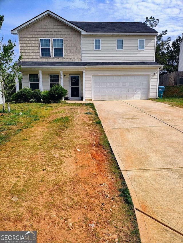 713 Dove Tree Ln, Social Circle, GA 30025 - traditional-style house with concrete driveway, an attached garage, fence, and a front yard