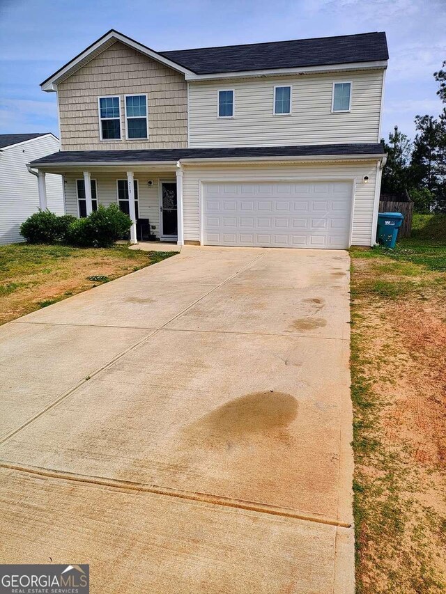 713 Dove Tree Ln, Social Circle, GA 30025 - traditional-style home with an attached garage and concrete driveway