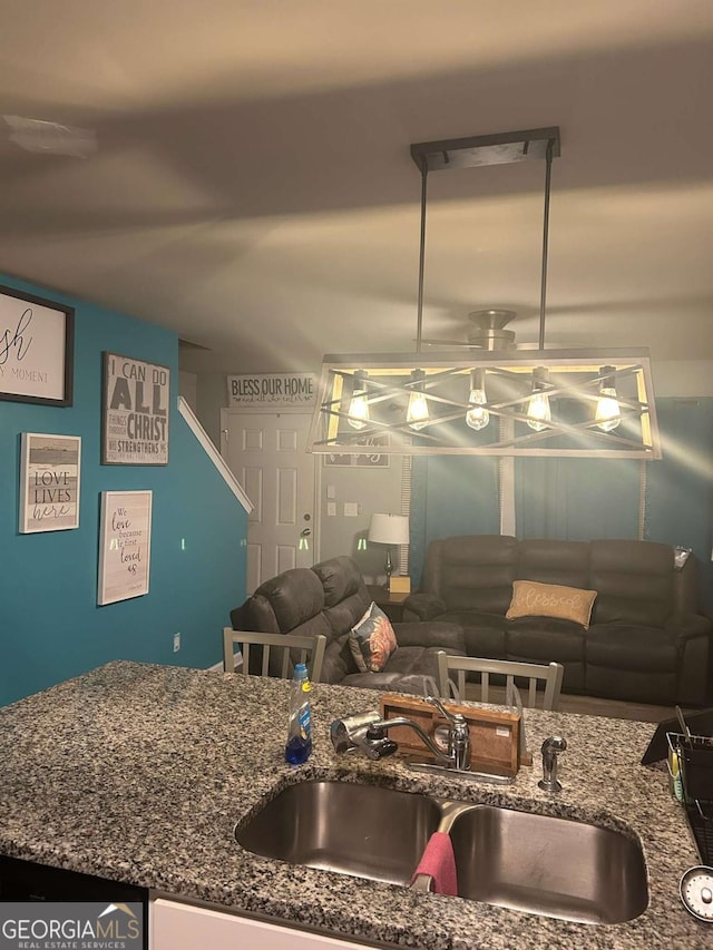 713 Dove Tree Ln, Social Circle, GA 30025 - kitchen with a sink and dark stone counters