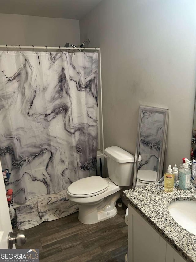 713 Dove Tree Ln, Social Circle, GA 30025 - bathroom with toilet, a shower with curtain, wood finished floors, and vanity