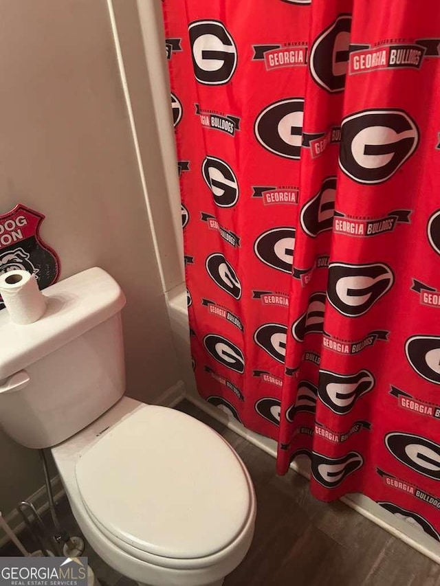 713 Dove Tree Ln, Social Circle, GA 30025 - full bath with a shower with curtain, toilet, and wood finished floors