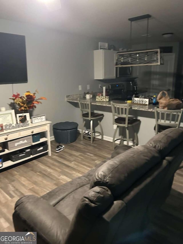 713 Dove Tree Ln, Social Circle, GA 30025 - living room with baseboards and wood finished floors