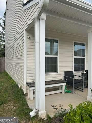713 Dove Tree Ln, Social Circle, GA 30025 - view of home's exterior featuring a porch and fence