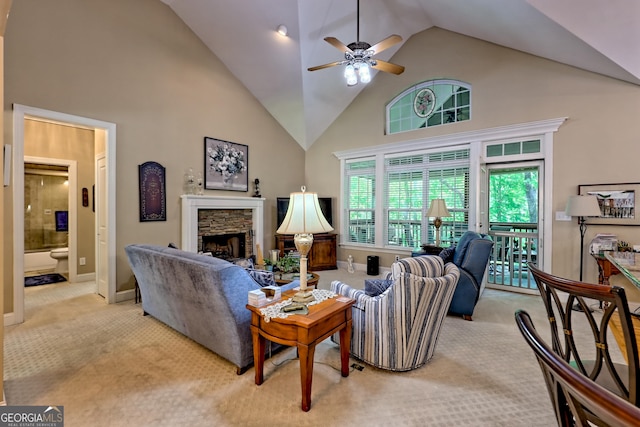 living room with carpet floors, ceiling fan, a fireplace, and high vaulted ceiling