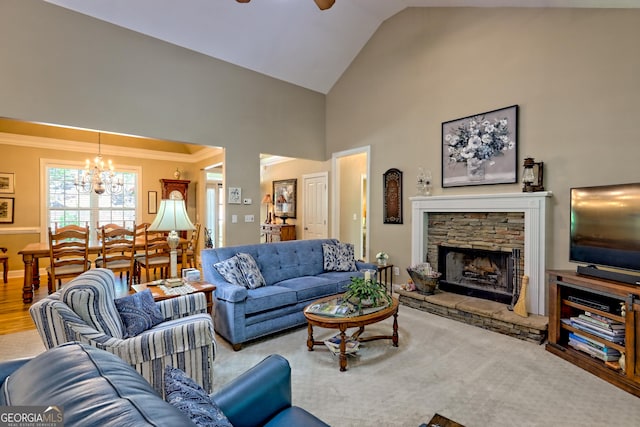 living area with high vaulted ceiling, ornamental molding, ceiling fan with notable chandelier, and a stone fireplace