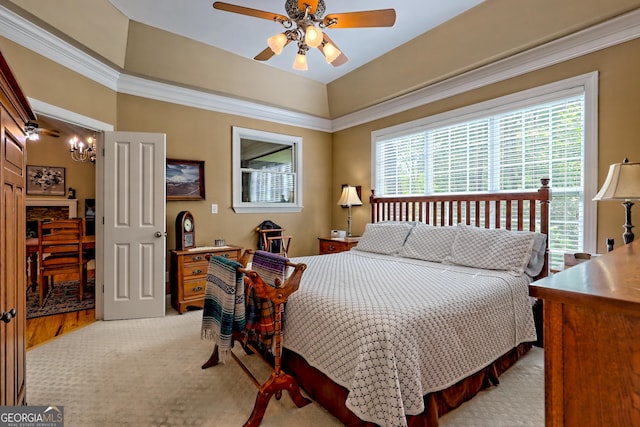 bedroom featuring ceiling fan with notable chandelier, light carpet, and multiple windows