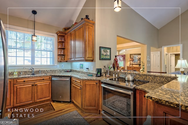 kitchen featuring a sink, high vaulted ceiling, brown cabinetry, and stainless steel appliances