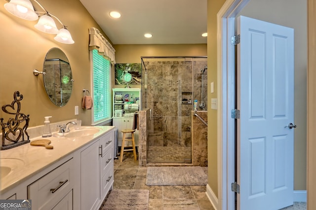 full bath featuring double vanity, recessed lighting, a shower stall, and a sink