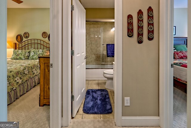 interior space with tile patterned floors and ensuite bath
