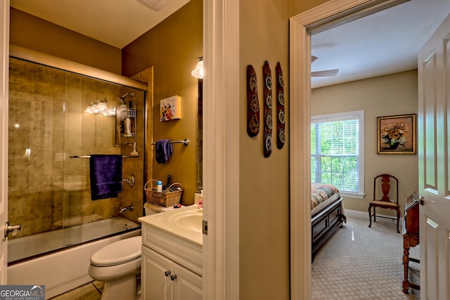 full bath with vanity, combined bath / shower with glass door, and toilet
