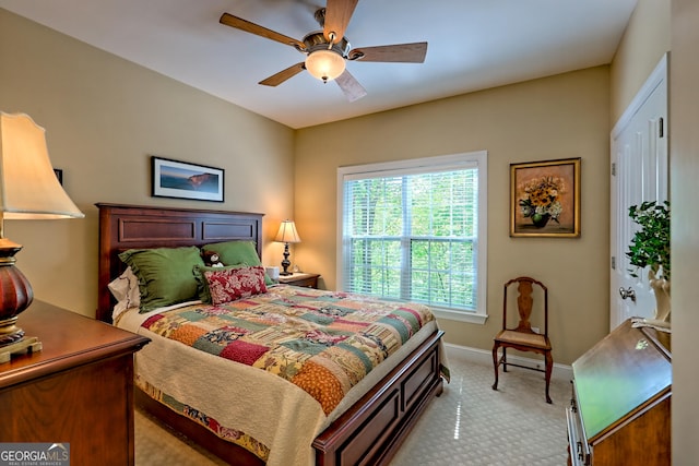 bedroom featuring a ceiling fan, baseboards, and light colored carpet