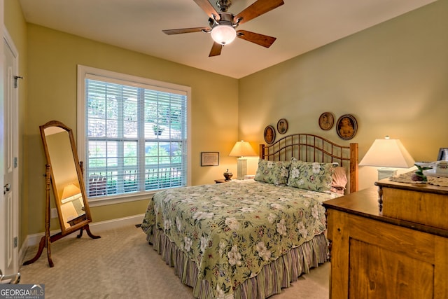bedroom with baseboards, ceiling fan, and light colored carpet