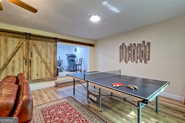 game room featuring baseboards, a ceiling fan, and light wood-style flooring
