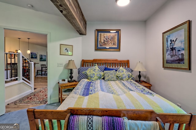 bedroom with baseboards and wood finished floors