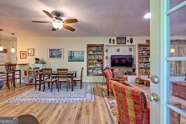 dining room featuring baseboards, ceiling fan, and wood finished floors
