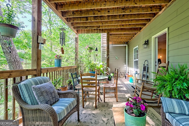 view of patio with a deck and outdoor dining space