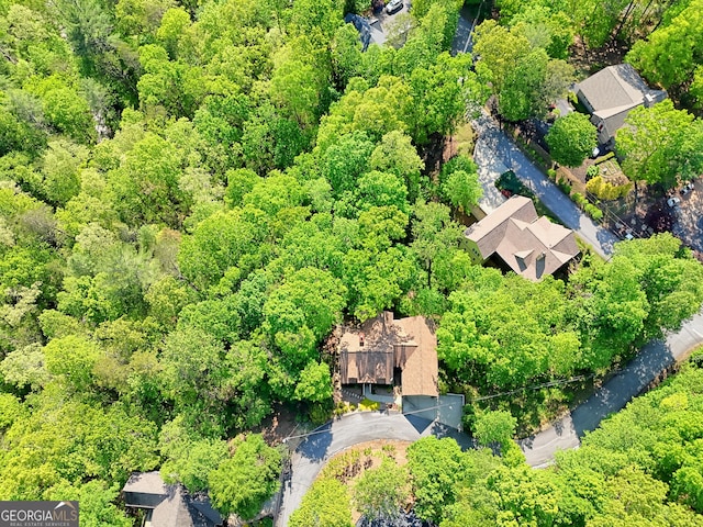 drone / aerial view featuring a wooded view