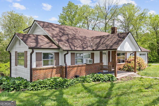 7255 Blue Ridge Dr, Blue Ridge, GA 30513 - view of front of house with a shingled roof, brick siding, a front yard, a chimney, and covered porch