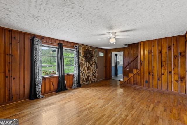 7255 Blue Ridge Dr, Blue Ridge, GA 30513 - unfurnished living room featuring stairs, wood walls, and hardwood / wood-style floors