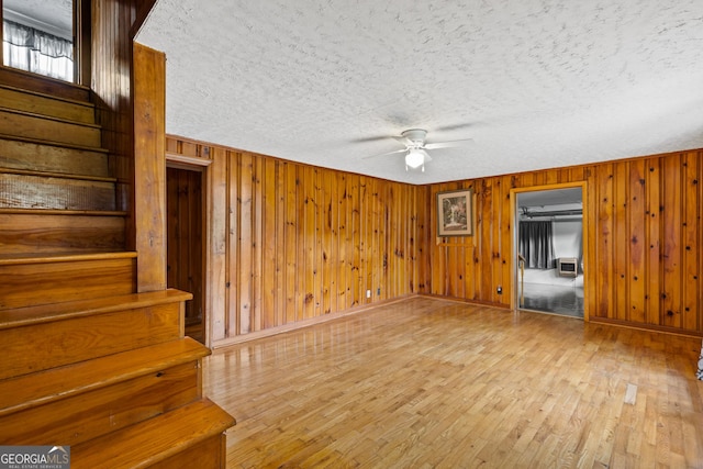 7255 Blue Ridge Dr, Blue Ridge, GA 30513 - unfurnished living room with stairway, a textured ceiling, ceiling fan, and wood finished floors