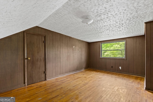 7255 Blue Ridge Dr, Blue Ridge, GA 30513 - bonus room with a textured ceiling, wood walls, hardwood / wood-style floors, and lofted ceiling