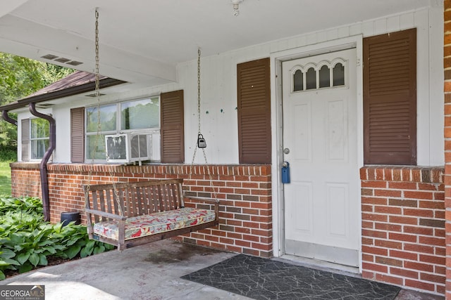 7255 Blue Ridge Dr, Blue Ridge, GA 30513 - entrance to property with brick siding, visible vents, and covered porch
