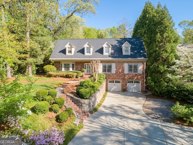 4584 E Conway Dr, Atlanta, GA 30327 - cape cod house featuring a garage, stairs, driveway, and brick siding
