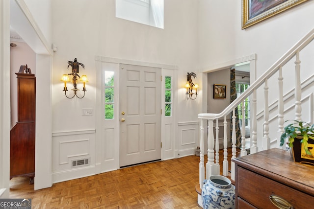 4584 E Conway Dr, Atlanta, GA 30327 - foyer featuring a towering ceiling, a wealth of natural light, a decorative wall, and visible vents
