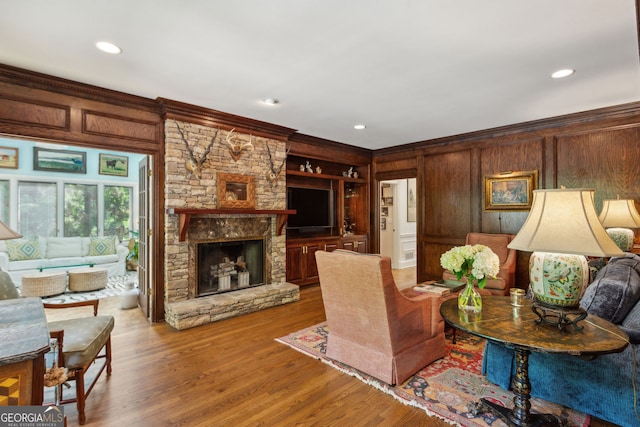 4584 E Conway Dr, Atlanta, GA 30327 - living room with wood walls, ornamental molding, and wood finished floors