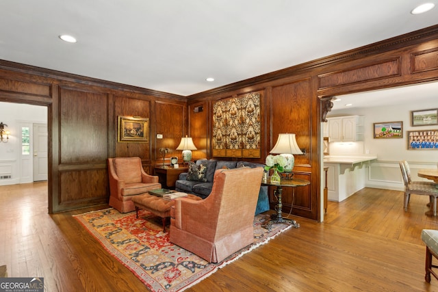 4584 E Conway Dr, Atlanta, GA 30327 - living room with crown molding, recessed lighting, a decorative wall, and wood finished floors