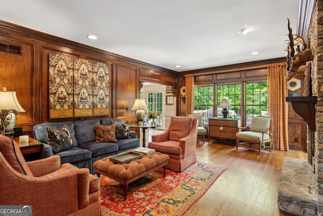4584 E Conway Dr, Atlanta, GA 30327 - living room featuring crown molding, wood-type flooring, wooden walls, and visible vents