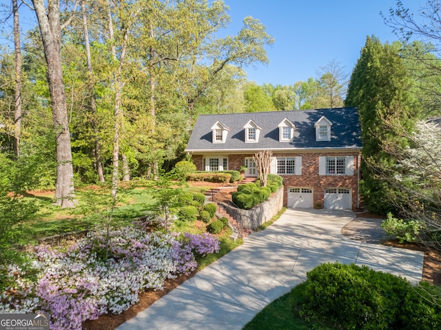 4584 E Conway Dr, Atlanta, GA 30327 - new england style home with concrete driveway, brick siding, and an attached garage