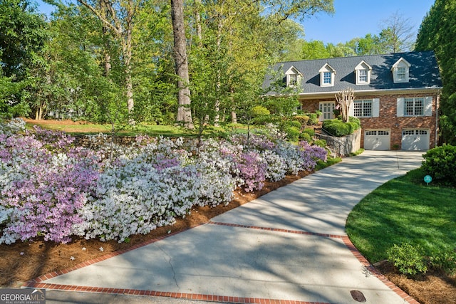 4584 E Conway Dr, Atlanta, GA 30327 - cape cod home with a garage, concrete driveway, and brick siding
