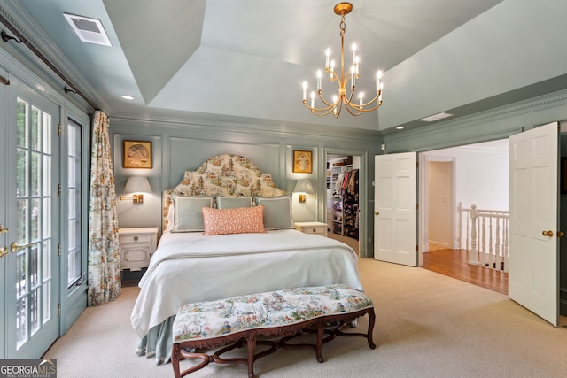 4584 E Conway Dr, Atlanta, GA 30327 - carpeted bedroom featuring visible vents, ornamental molding, a tray ceiling, a chandelier, and a spacious closet