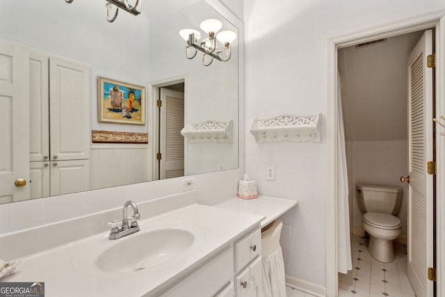 4584 E Conway Dr, Atlanta, GA 30327 - bathroom with visible vents, vanity, tile patterned floors, toilet, and a chandelier