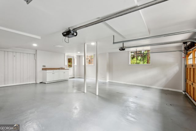4584 E Conway Dr, Atlanta, GA 30327 - garage featuring recessed lighting, baseboards, and a garage door opener