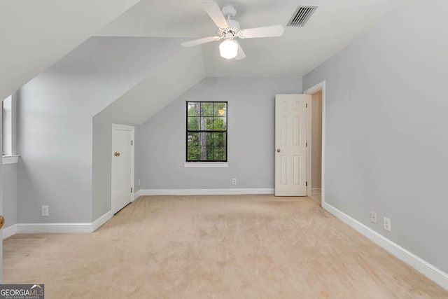 additional living space with carpet floors, a ceiling fan, baseboards, vaulted ceiling, and visible vents