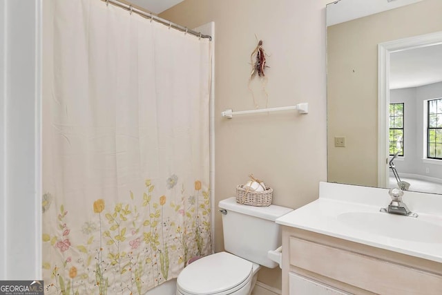 full bath with vanity, a shower with shower curtain, and toilet