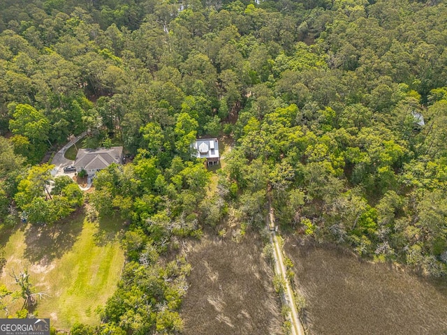 birds eye view of property featuring a wooded view