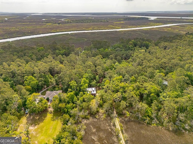 birds eye view of property featuring a view of trees